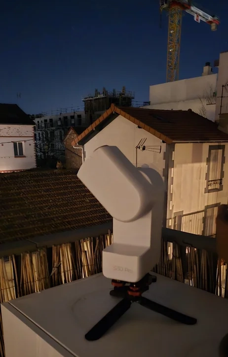 A Seestar S30 Pro on a Paris balcony, with a construction crane behind it
