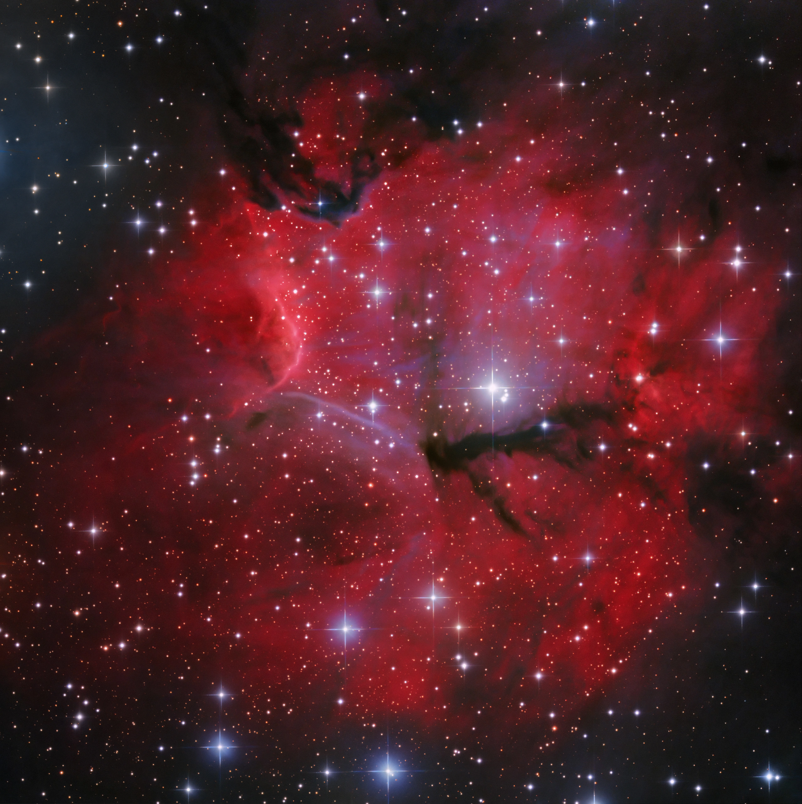 Gum 15, a faint HII region in Vela being carved open by the hot young stars forming inside it