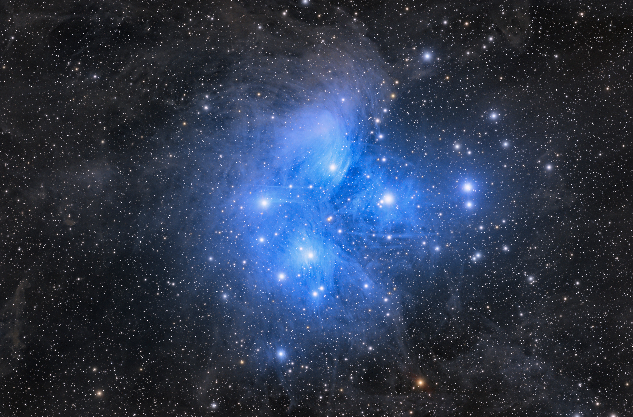 The Pleiades Messier 45, hot blue stars ploughing through a dust cloud that scatters their light